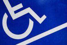 Image of a blue and white handicap sign for an article about the basics of wheelchair maintenance and cleaning.