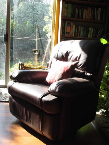 Image of a brown leather livingroom recliner for an article about the different types of stairlifts.